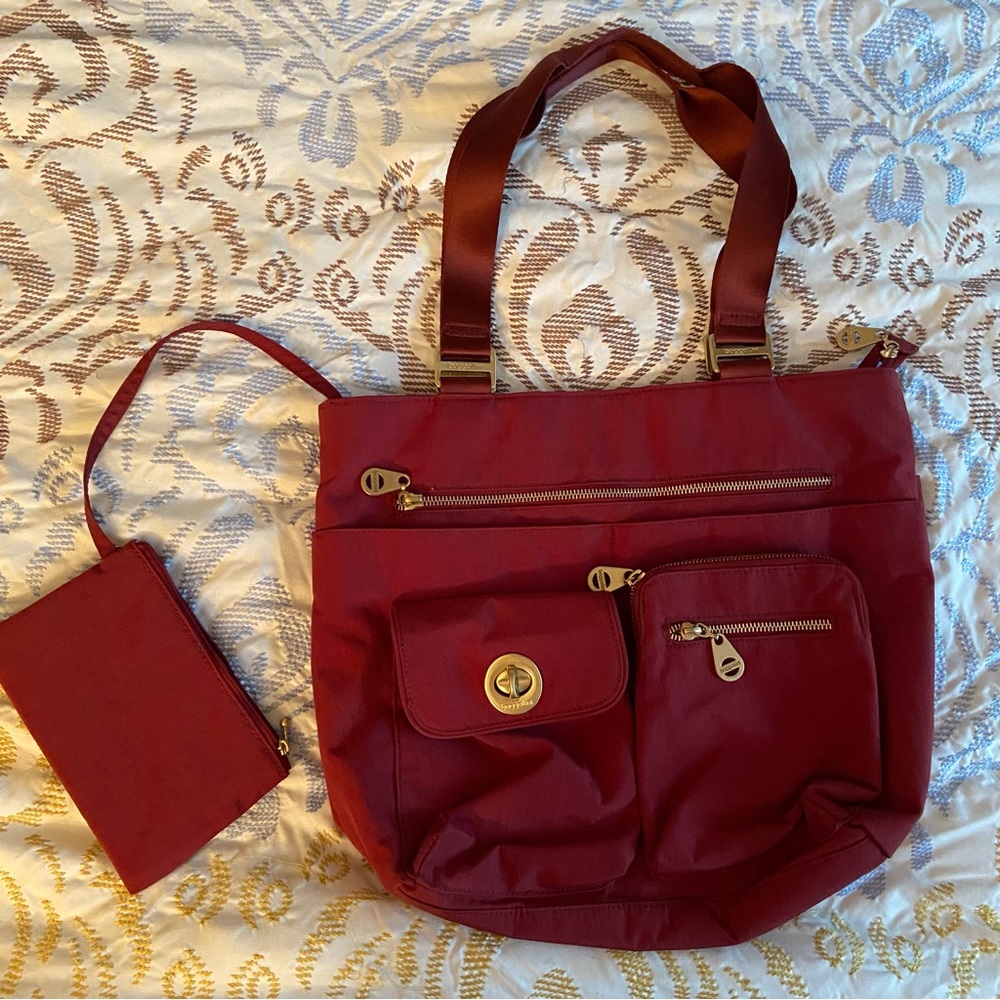 Baggalini tote bag - never used. Like new. Gold fasteners dress it up.